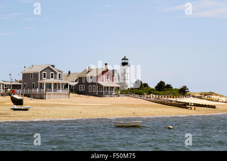 Isolated cottages and Sandy Neck Lighthouse seen from the water, Cape Cod, Massachusetts Stock Photo