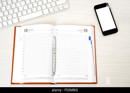 Workplace with phone and notepad, and coffee Stock Photo