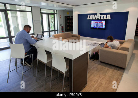 Two UCT GSB students working on laptops in a lounge Stock Photo
