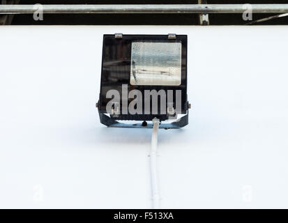 Modern industrial lamp on the factory wall. Stock Photo