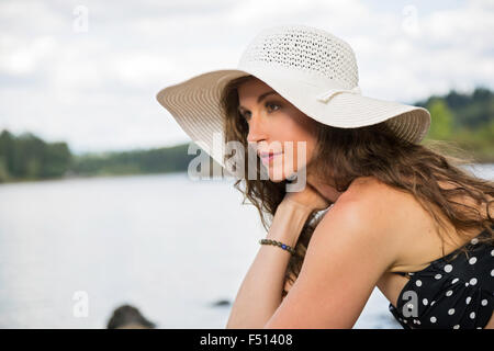 Beautiful athletic woman enjoying the outdoors by the river during summer time Stock Photo