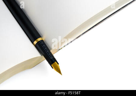 Ink pen on open book Stock Photo