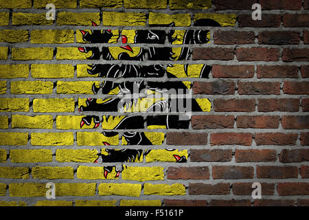 Dark brick wall texture - flag painted on wall - Flanders Stock Photo