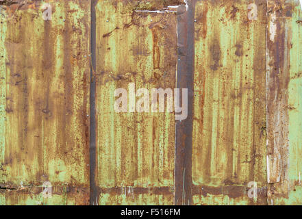 Fragment of a fence from a rusty metal sheets. Stock Photo