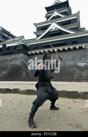 Ninja warrior posing in front of famous Kumamoto Castle in Kyushu Japan Stock Photo