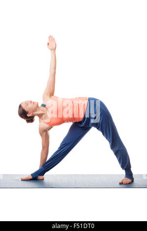 Woman practices yoga asana utthita trikonasana Stock Photo