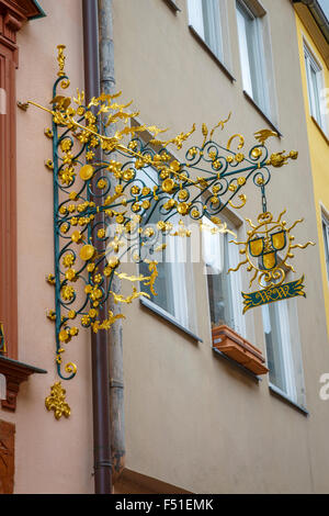 Ornate retailers sign hanging on Weißgerbergasse, a street in Nuremberg famous for it's medieval half-timbered architecture. Stock Photo