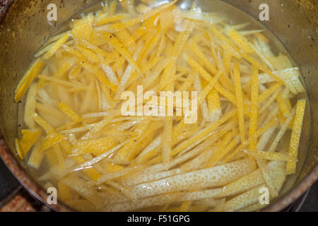 Candying lemon peel, in a pot full of syrup Stock Photo