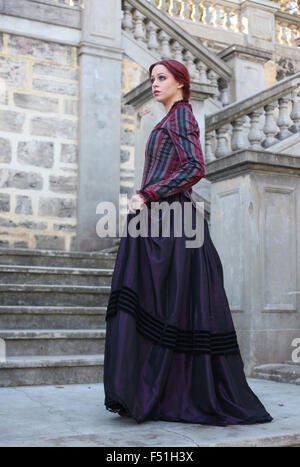 Portrait of a beautiful red haired girl wearing  Gothic inspired Victorian era clothes. Stock Photo