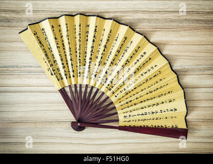 Traditional eastern fan on the wooden background. Fashion accessory. Stock Photo