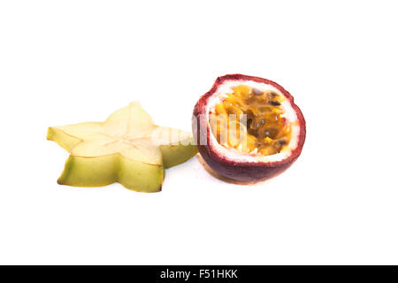 A green carambola and a colorful  passion fruit, on white background Stock Photo