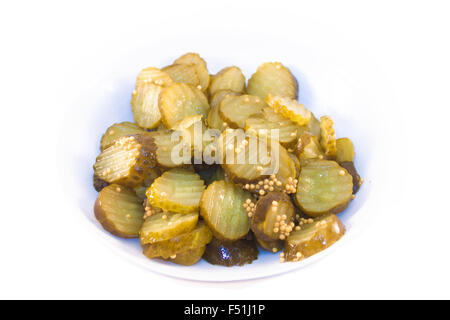 Pickled green cucumbers, on a white plate, isolated on white background Stock Photo