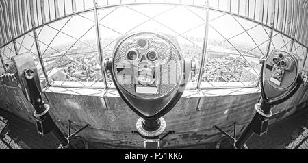Black and white fisheye lens toned photo of tourist binoculars over Manhattan, New York City, USA.