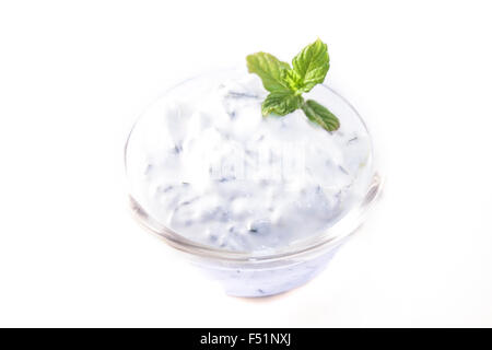 A glass bowl full of tzatsiki, isolated on white background Stock Photo