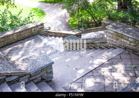 Stairs made of stone, heading down to a park Stock Photo