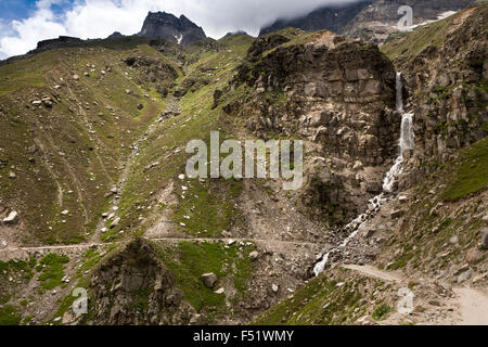 India, Himachal Pradesh, Lahaul Valley, Chhatru, meltwater stream flowing over road to Kunzum La Pass Stock Photo