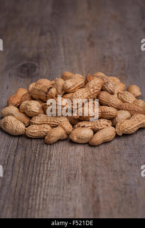 Monkey nuts in a pile on a wooden surface Stock Photo