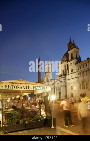 Pizzeria in Piazza Navona, Rome, Italy with the 17th century baroque Chiesa di Sant'Agnese in Agone behind. Stock Photo