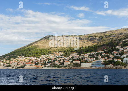 View of buildings on the hillside and Mount Srd from the sea in Dubrovnik, Croatia. Copy space. Stock Photo