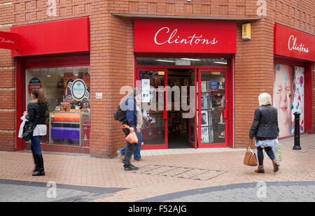 People Passing by Clinton Cards retail gift store business. Clintons corner shop selling greeting cards, Victoria St, town centre Blackpool. Stock Photo