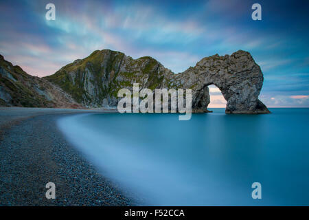 Colorful sky at dawn over Durdle Door along the Jurassic Coast, Dorset, England