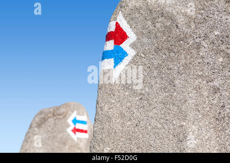 Trail signs painted on rock, choice or dilemma concept. Stock Photo