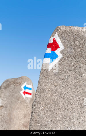 Trail signs painted on rock, choice or dilemma concept. Stock Photo