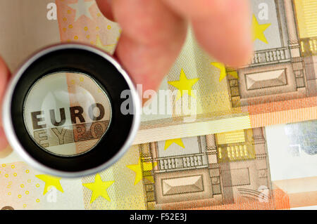 Euro Banknotes Under Magnifying Glass, Close-up Stock Photo