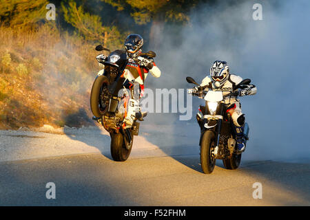 Motorcycles, Funbikes, Husquarna Nuda 900R and KTM 990 SMC, moving on country road, Wheelie and Burnout, Stock Photo