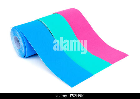 some rolls of elastic therapeutic tape of different colors, pink and two different shades of blue, on a white background Stock Photo