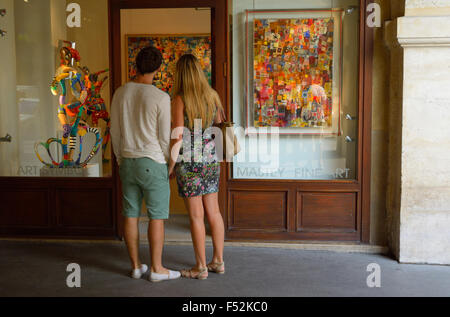 A Couple in front of an art gallery at Place des Voosges, Paris FR Stock Photo