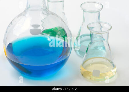 Different colored reagents in assorted laboratory flasks. Stock Photo