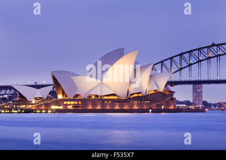 Sydney opera house and Harbour bridge in Sydney at sunset. Iconic and world famous landmark of Australia. Stock Photo