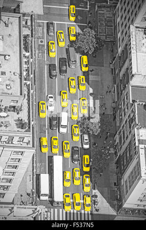 Old film style photo of New York taxis from above, black and white picture with yellow cabs in Manhattan, USA. Stock Photo