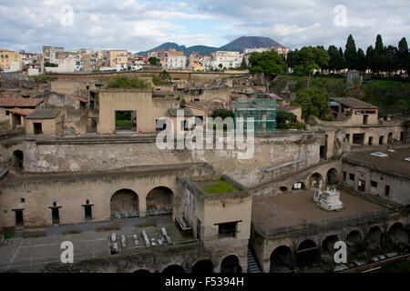 Italy, Herculaneum. City covered with ash when Mt. Vesuvius erupted in 79 A.D. where it stayed buried for more than 1,600 years. Overview of city ruins with Mt. Vesuvius in the distance. Stock Photo