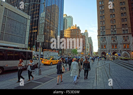 NEW YORK, USA - MAY 06, 2015: People walk along 6th Avenue in New York City, USA. Sixth Avenue is a major thoroughfare in NYC's Stock Photo