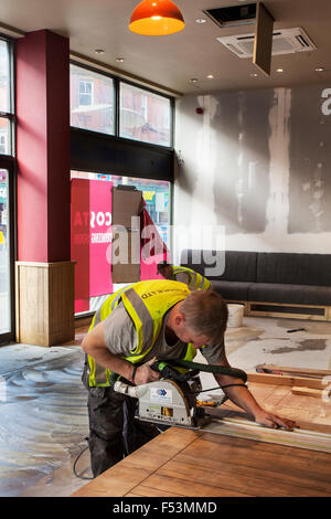 Costa Coffee Expansion &  refurbishment, continues as new cafe bar due to open.  Workmen of various skills are putting together the final finish to the corporate design which has proved so successful.   The Whitbread -owned business plans to grow its UK store base to around 2,500 in 2020, up from 1,931. Costa’s UK sales rose 16.2% in the last year, for instance, with 4.6% growth in transactions per store. Stock Photo