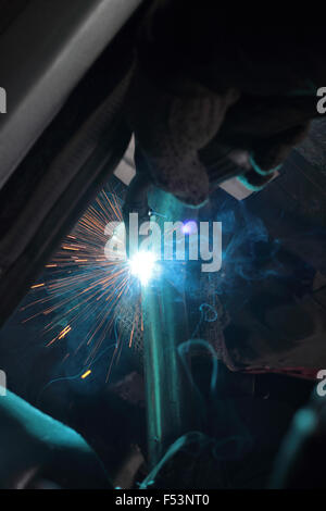 Sparks from electric welding at car repairs. Stock Photo