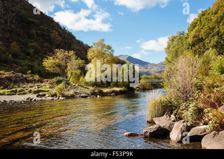 Afon Glaslyn River flowing out of Llyn Dinas lake in early autumn in Nantgwynant valley in Snowdonia National Park (Eryri). North Wales UK Stock Photo