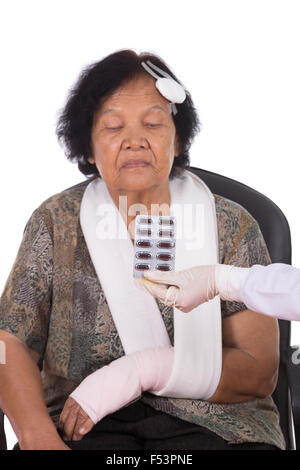 pills with senior woman injured on white background Stock Photo