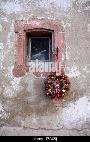 Christmas wreath with owl, hanging on window of old building, Alsace window, France Stock Photo
