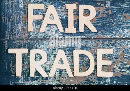 Fair trade written on rustic wooden surface Stock Photo