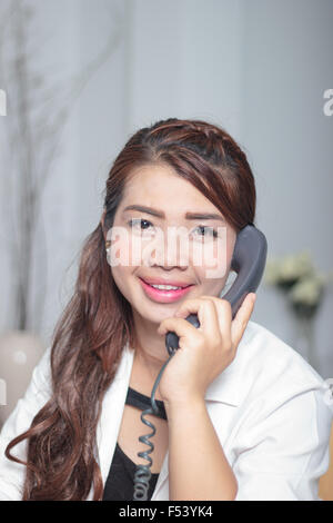 Asia woman using a telephone Stock Photo