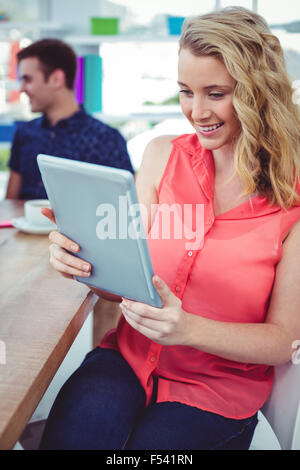 Smiling creative businesswoman working with co-workers Stock Photo