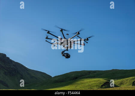 Remote controlled  Drone flying with a camera by Skogafoss Waterfalls, Iceland Stock Photo