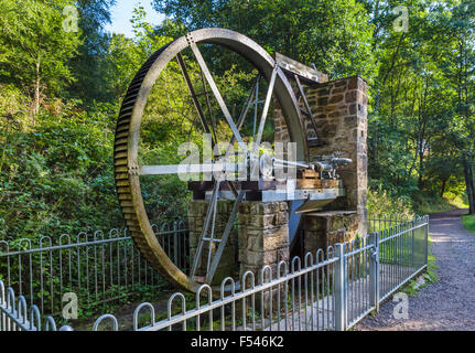 Water wheel by the side of the trail to the Power House at Cragside, Rothbury, Northumberland, England, UK Stock Photo