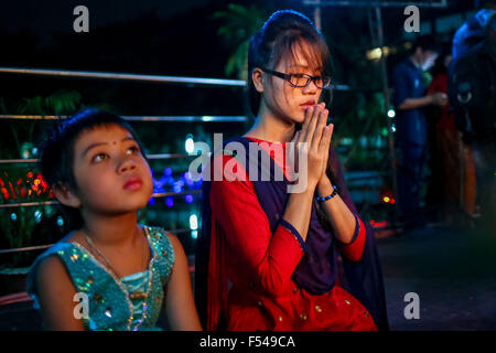 Dhaka, Bangladesh. 27th Oct, 2015. Oct. 27, 2015 - Dhaka, Bangladesh - Buddhist celebrating Pravarana Punnama.The Assayujjiya Punnama or the full moon day of Assayujjiya (September-October) also known as the Pravarana Punnama. This full moon day signifies the end of the three month Lent of Bhikkhus. Other functions of the festival include the offering the offering of the Buddha Puja in the morning, feeding the monks in fornoon, illumimination of the monastery in the evening by lighting candles like the Diwali of Hindus, vows of Pancha Sila or Attha Sila by the elders and keeping the Sabbath Stock Photo