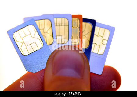 Mobile Phone SIM Cards Held Between the Fingers of a man Stock Photo