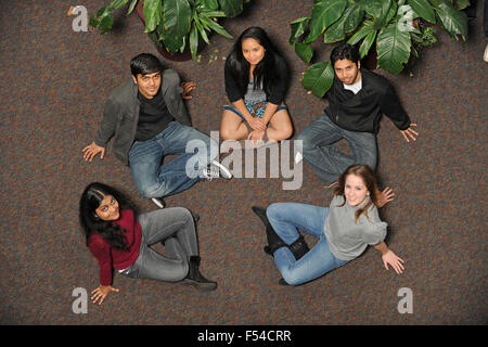 Ethnically diverse group of students sitting on floor Stock Photo