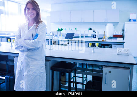 Scientist smiling at the camera in lab Stock Photo
